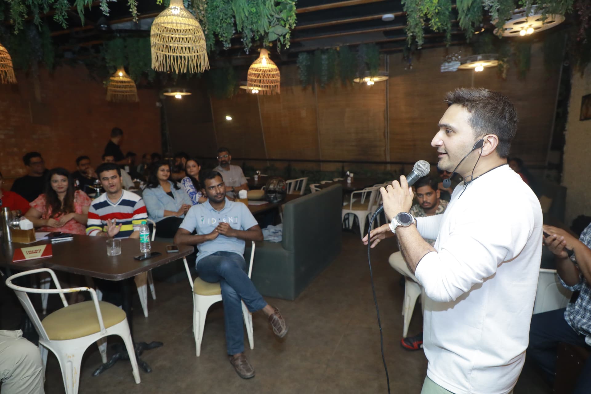 Speaker with a microphone at a Music Jammin cafe session