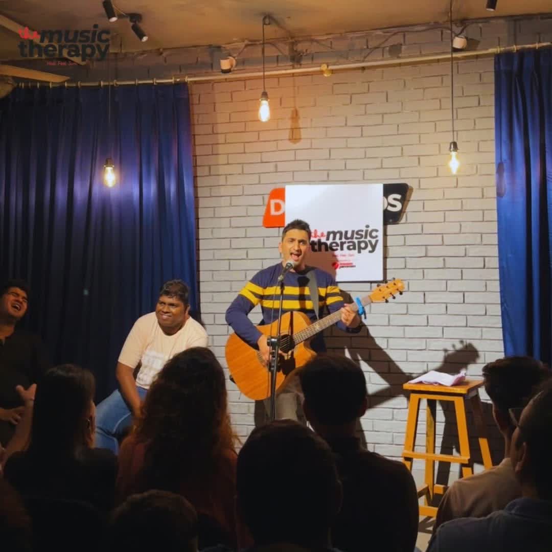 Artist performing on stage at a Music Therapy session